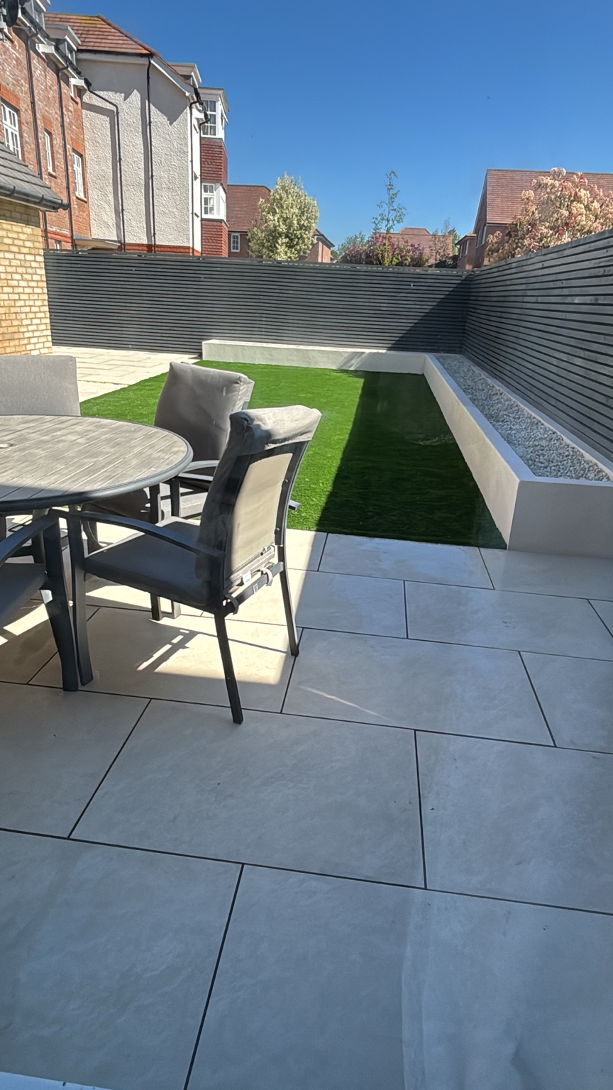 Completed Herne Bay garden with porcelain paving, artificial grass and slatted fencing